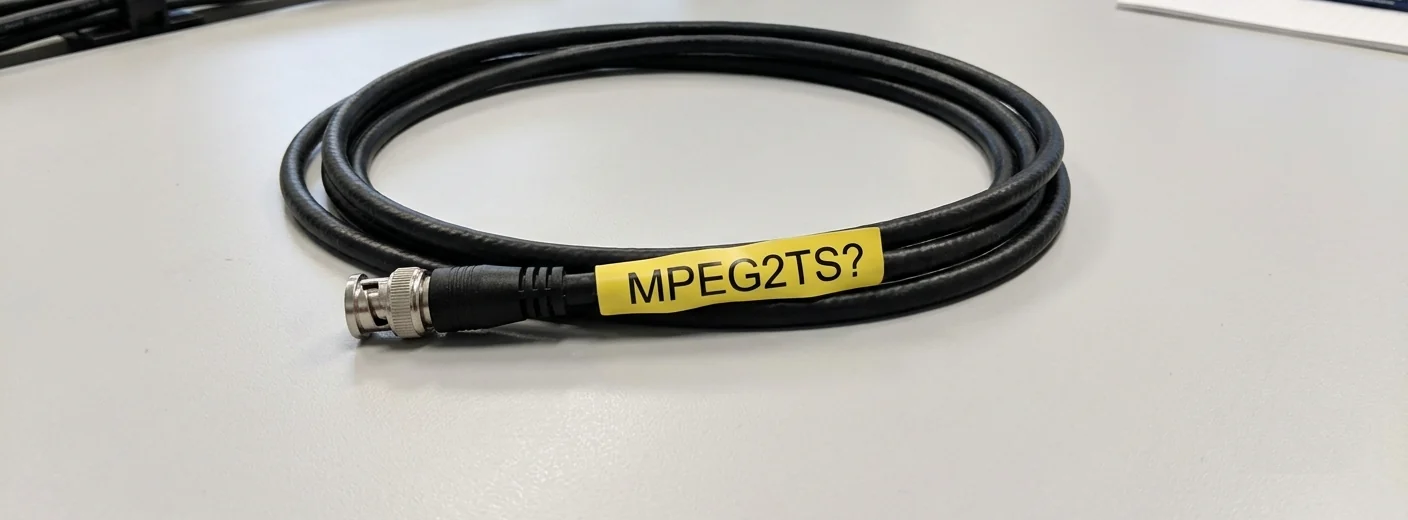 A coiled SDI and coax cable labelled MPEG2TS, representing the bridge between installed broadcast systems and Media over QUIC.